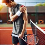 Osteopath treating a patient's shoulder injury and rotator cuff pain.