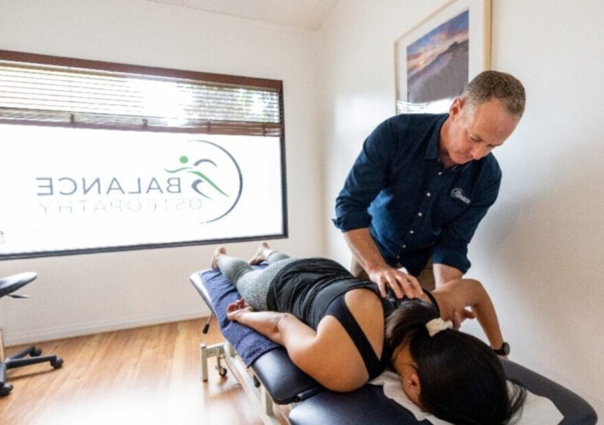 Osteopath guiding a patient through rehabilitation exercises at Balance Osteopathy Melbourne